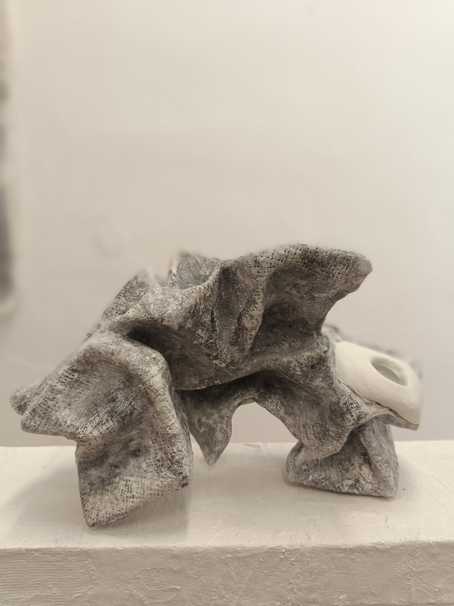 Horizontal Hole Object with layered grey surfaces and multiple openings