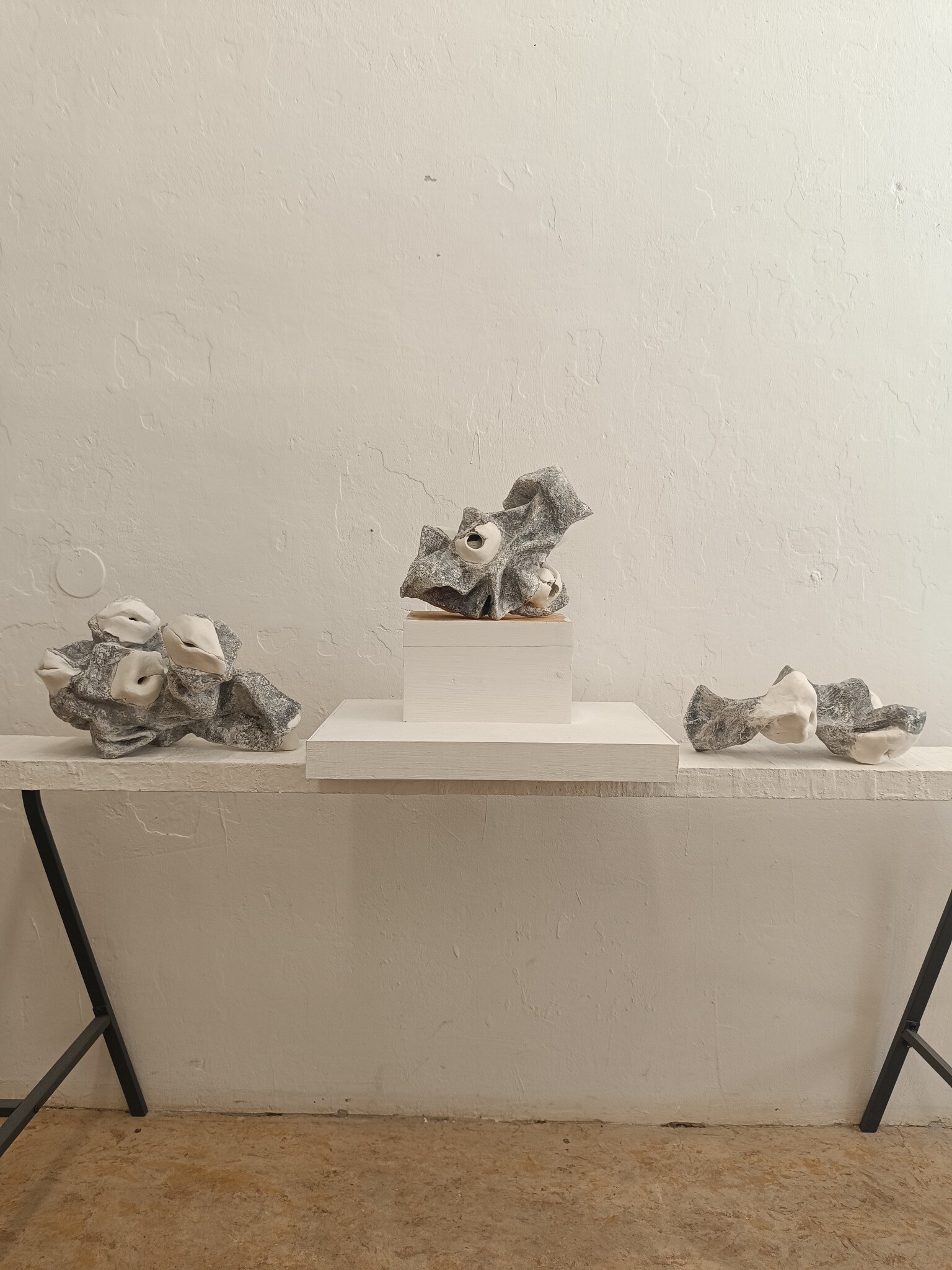 Three Hole Objects arranged on a long studio table