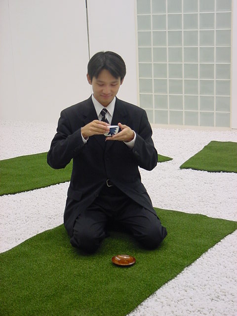 Tatami Landscape, participant kneeling on an artificial-grass tatami