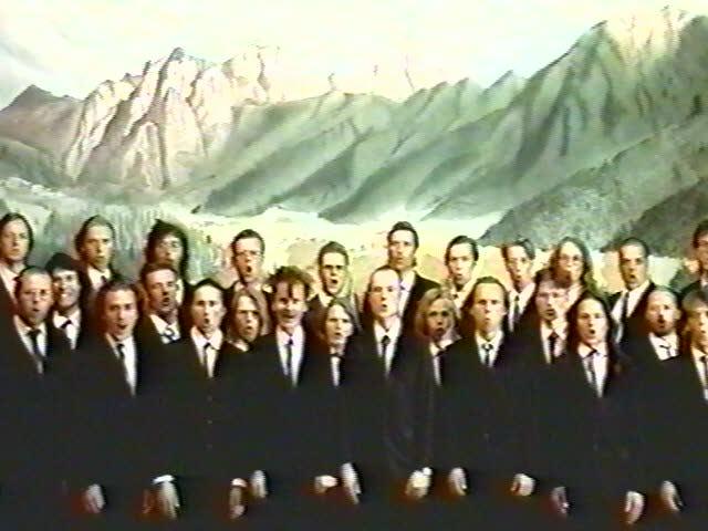 Members of Mieskuoro Huutajat in front of a constructed Alpine backdrop