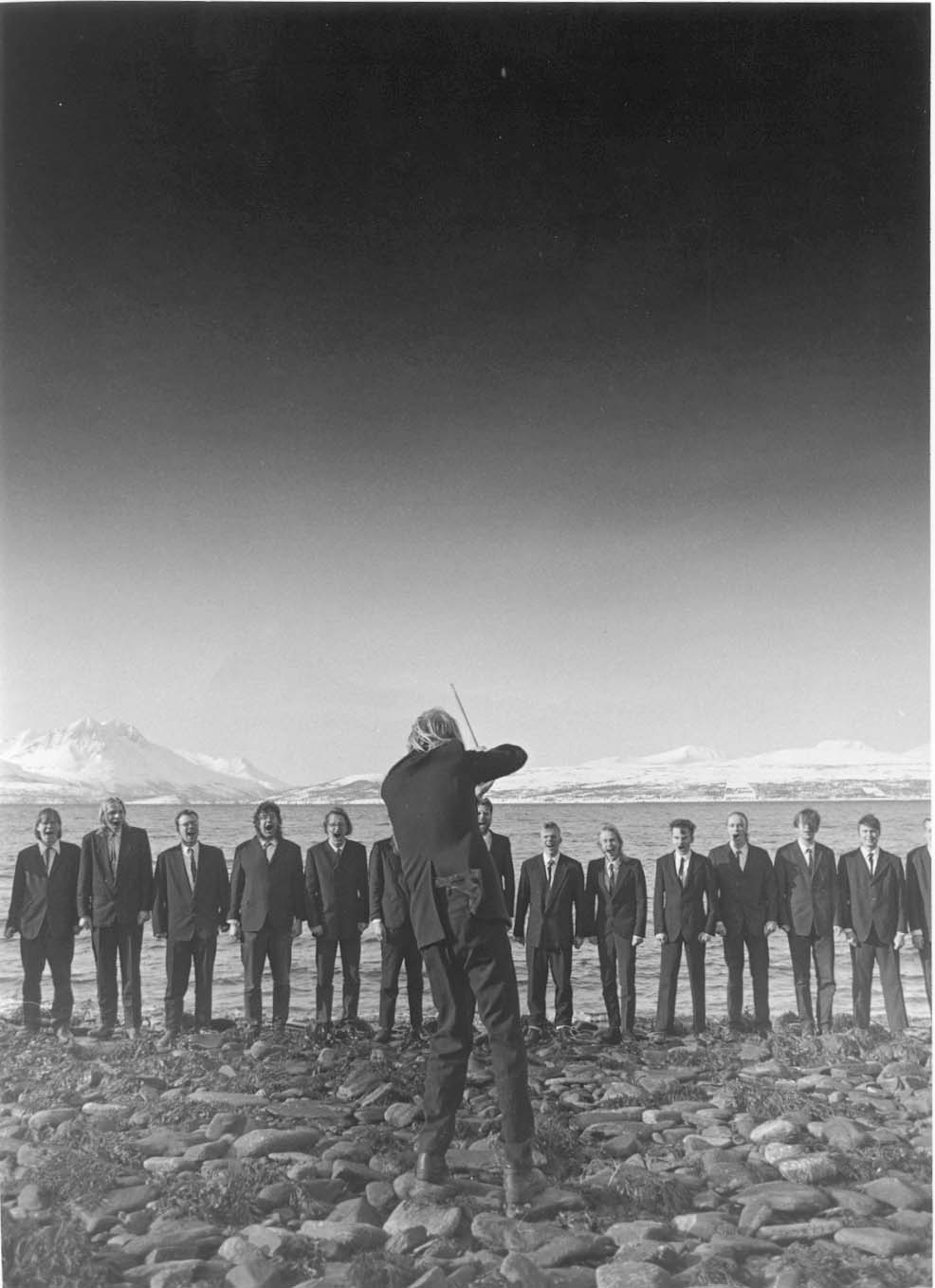 Mieskuoro Huutajat performing in a mountain landscape